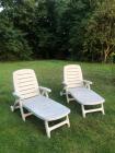 Twee witte inklapbare tuin ligstoelen